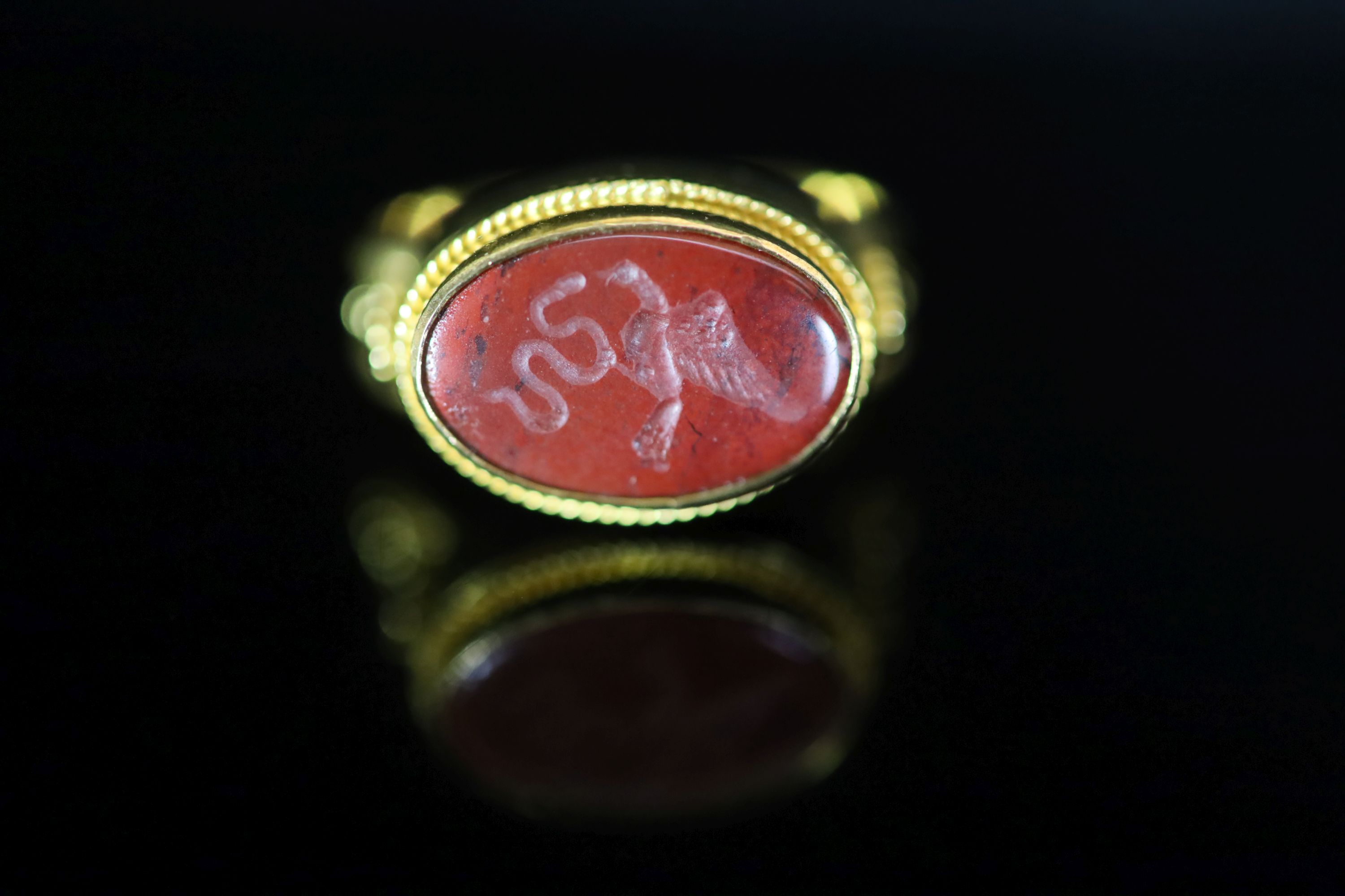 A Venetian 22ct gold and antique oval carnelian set signet ring